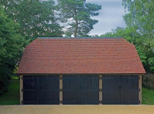 This oak frame has barn hip end roof, finished in a clay tile with a contrasting clay ridge.