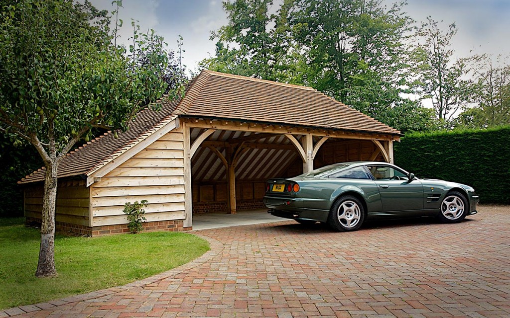This two-bay cart barn open garage is fully hipped, and has a full length enclosed log store.