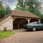 This two-bay cart barn open garage is fully hipped, and has a full length enclosed log store.