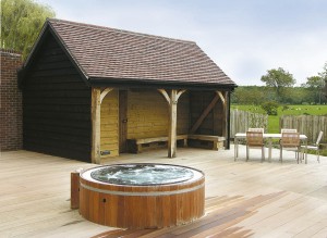 This open fronted oak framed building provides a seating area for guests using the hot tub in a New Forest Hotel, Hampshire.